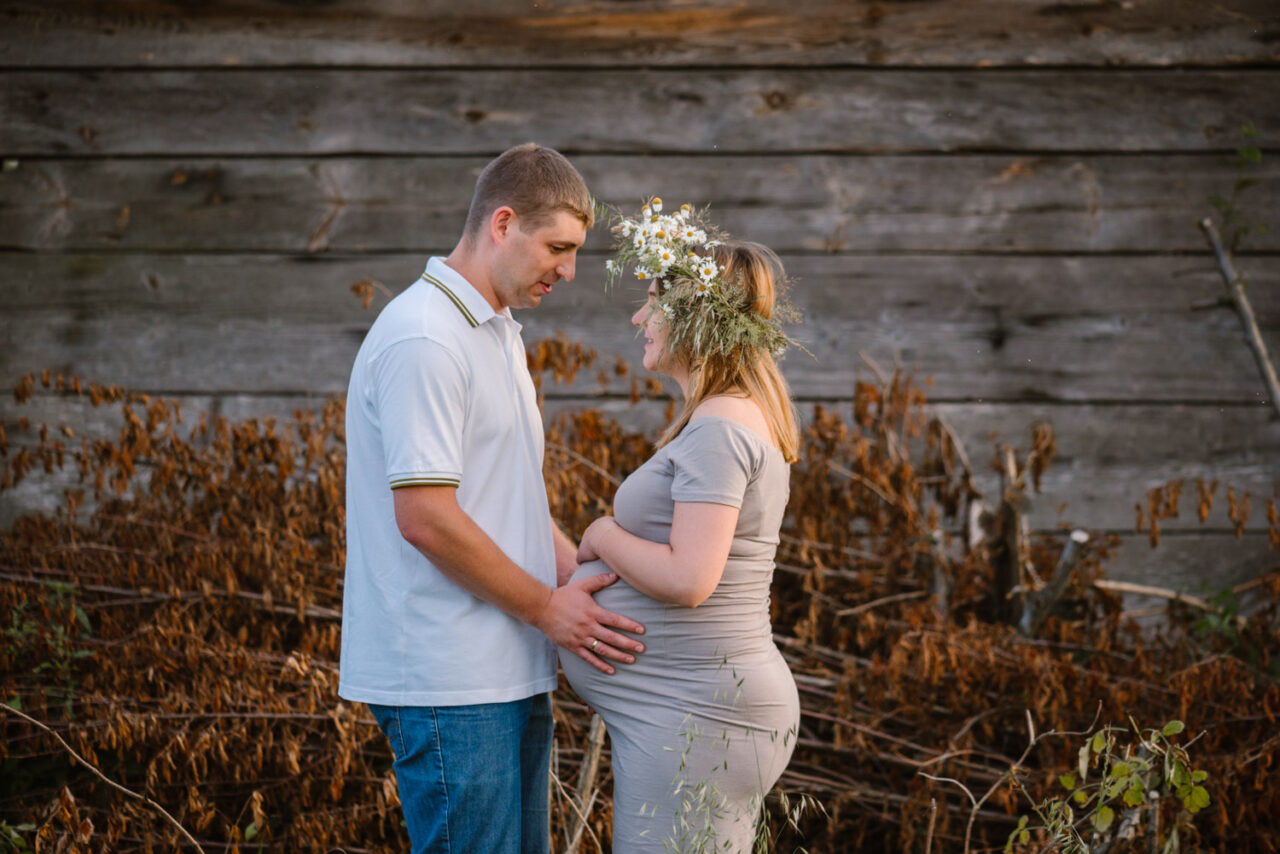 mąż trzymający brzuch żony