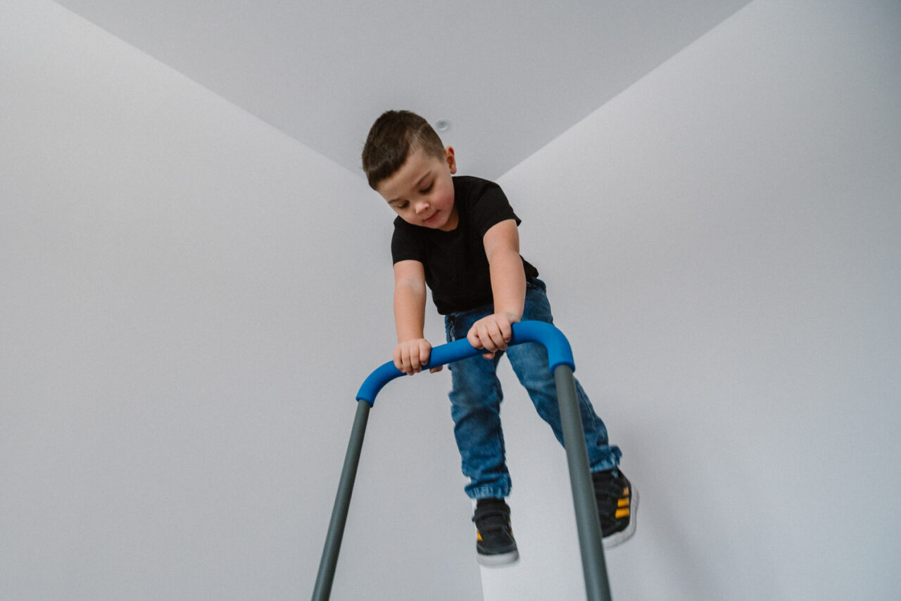 chłopak skaczący na tle ścian w domu